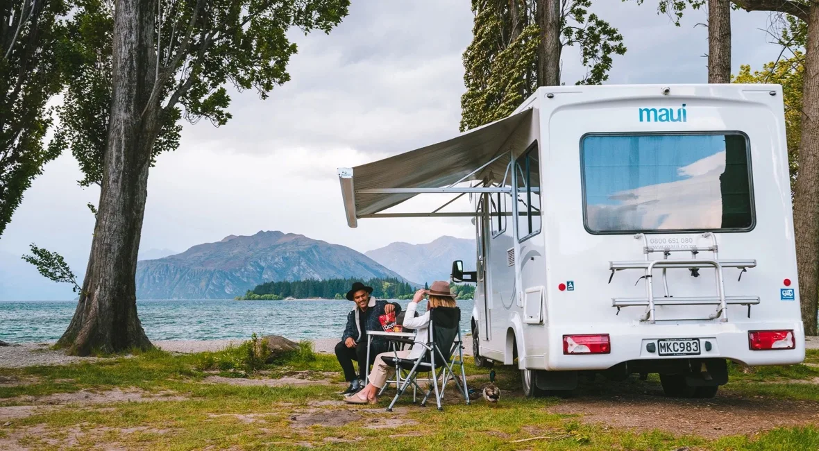 Campervan parked next to a New Zealand beach.